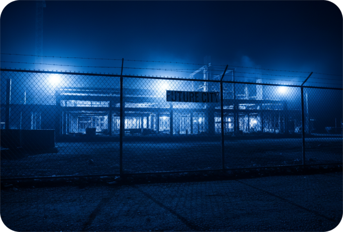 Fenced construction site at night